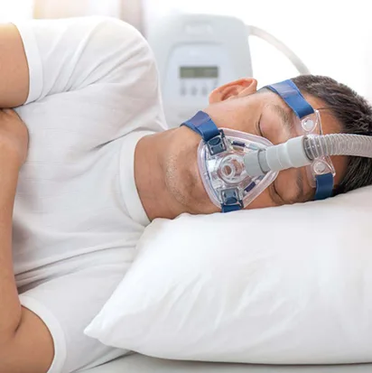 Man sleeping on his side wearing a full-face CPAP mask