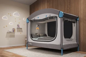 A full view of the Cubby Bed special needs safety bed shown set up in a child’s room with the canopy open.